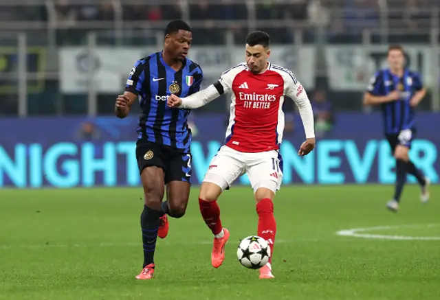 Denzel Dumfries of FC Internazionale and Gabriel Martinelli of Arsenal compete for the ball