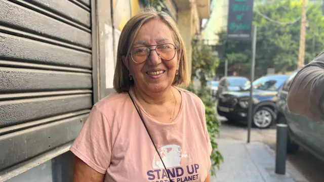 Wafa Karameh standing in a street wearing a pink T-shirt