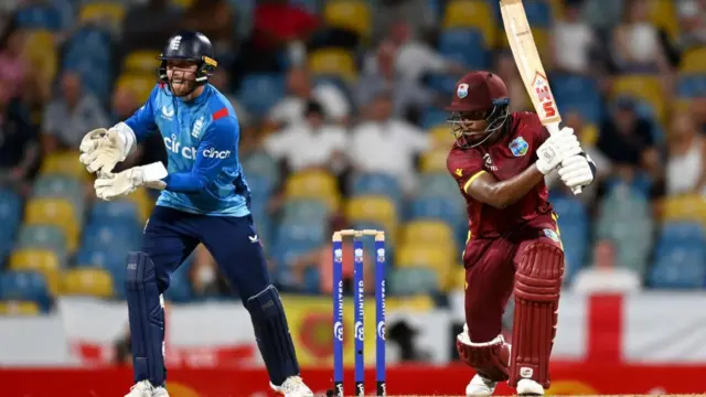 Keacy Carty of the West Indies bats watched by England wicketkeeper Phil Salt