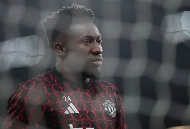 Goalkeeper Andre Onana of Manchester United warms up