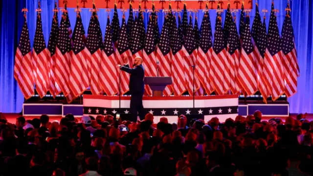 A worker prepares the stage during the election night event with former US President Donald Trump, not pictured, at the Palm Beach Convention Center in West Palm Beach, Florida, US, on Tuesday, Nov. 5, 2024. The 2024 presidential campaign was marked by two assassination attempts, a candidate switch, divisive rhetoric and warnings about the fate of democracy. Photographer: Eva Marie Uzcategui/Bloomberg via Getty Images