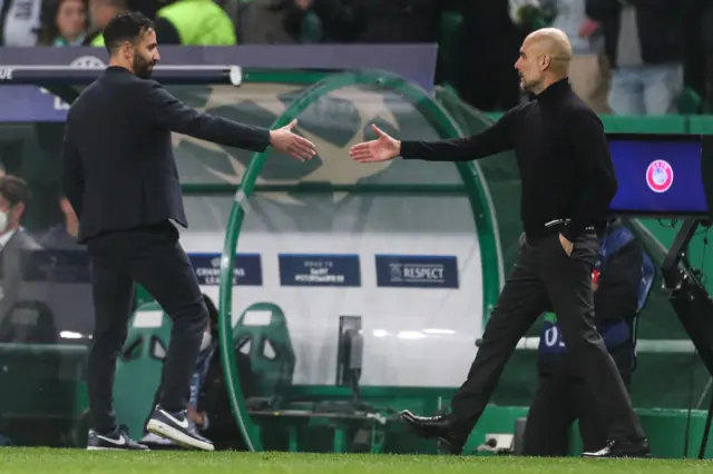 Sporting Lisbon's Portuguese coach Ruben Amorim (L) greets Manchester City's Spanish manager Pep Guardiola