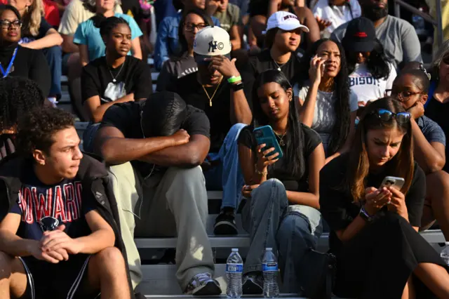 Young Howard students wait in the bleachers