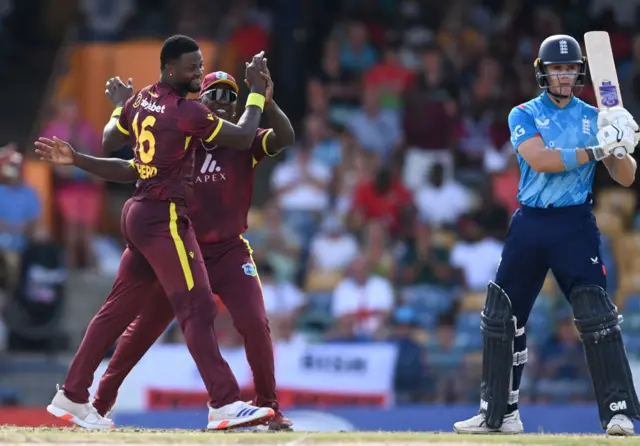 Romario Shepherd of the West Indies celebrates with Sherfane Rutherford after dismissing Jacob Bethell