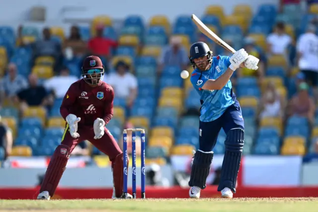 Phil Salt of England bats watched by West Indies wicketkeeper Shai Hope