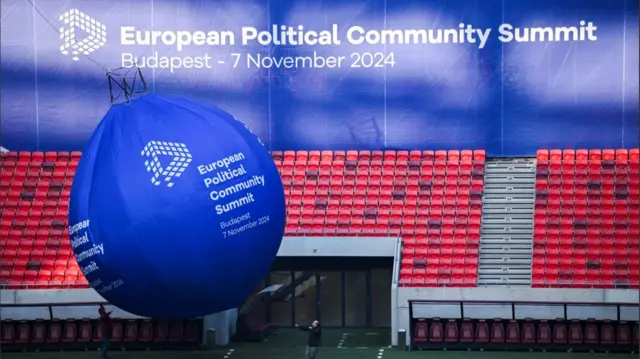 People put up a balloon sign at the European Political Community Summit venue