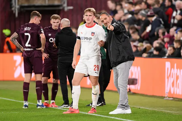 Frank Schmidt, Head Coach of 1.FC Heidenheim 1846, interacts with Mikkel Kaufmann