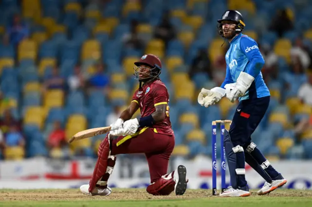 Keacy Carty of the West Indies bats watched by England wicketkeeper Phil Salt