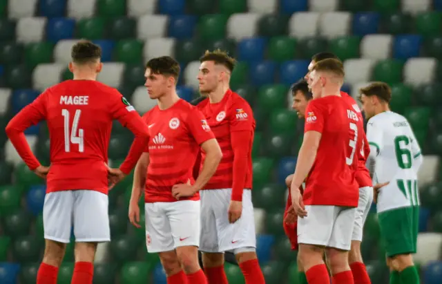 Larne players dejected at full-time