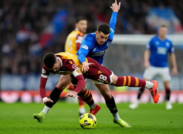 Tom Lawrence challenges a Motherwell player during their Scottish League Cup semi-final defeat by Rangers