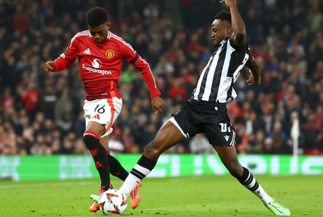 Manchester United's Amad Diallo in action with PAOK's Abdul Rahman Baba