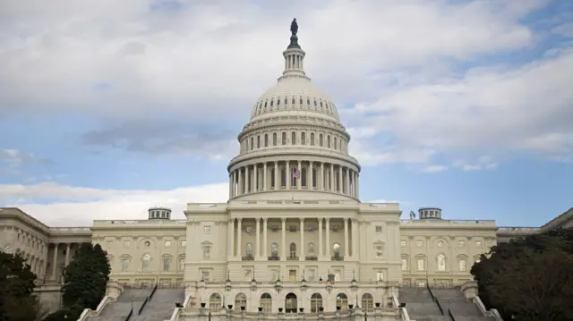 Frontal shot of Capitol building with US flag flying at top