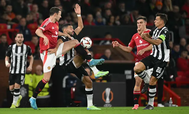 Jonny Evans (L) vies with PAOK's Moroccan striker #34 Tarik Tissoudali