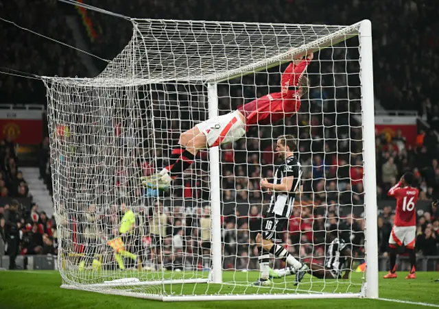 9 Rasmus Hojlund hangs off of the crossbar