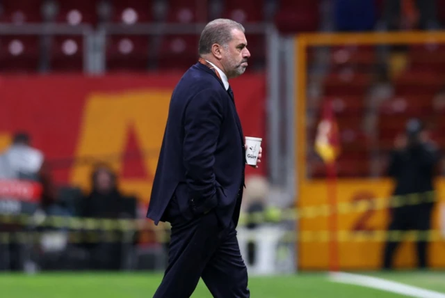 Tottenham Hotspur manager Ange Postecoglou walks on the pitch before the match