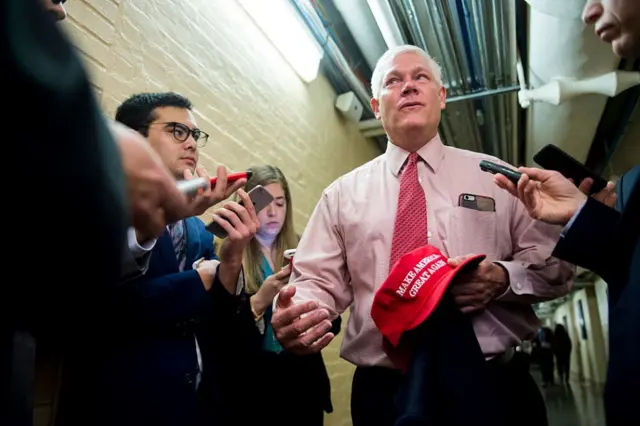 5: Rep. Pete Sessions, R-Texas, holding a "Make America Great Again" hat, speaks with reporters as he leaves the House Republican Conference meeting in the U.S. Capitol on Tuesday,