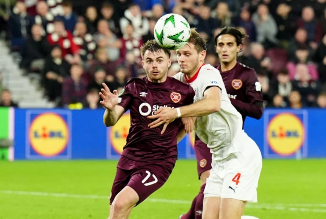 Heart of Midlothian's Alan Forrest (left) and Heidenheim's Tim Siersleben battle for the ball