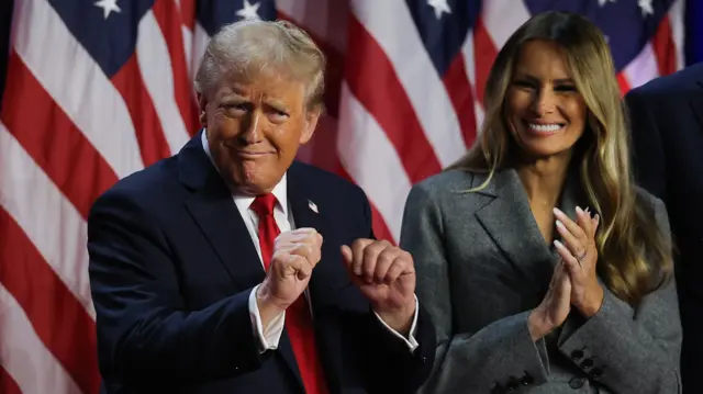 Republican presidential nominee and former U.S. President Donald Trump dances accompanied by Melania Trump who is applauding her husband