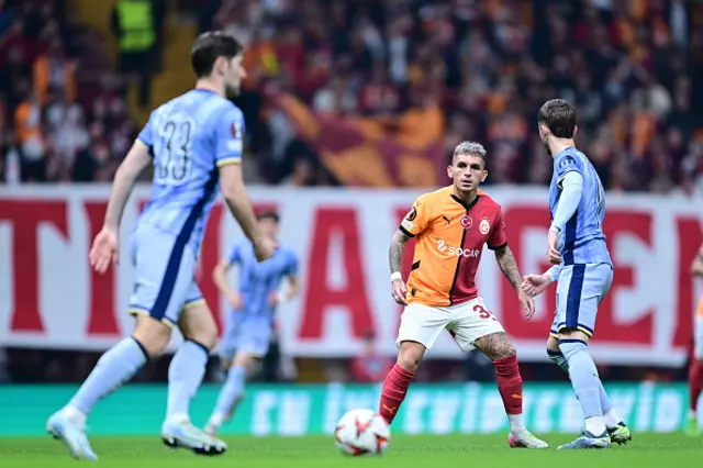 Lucas Torreira (C) of Galatasaray and Ben Davies (L) of Tottenham Hotspur compete