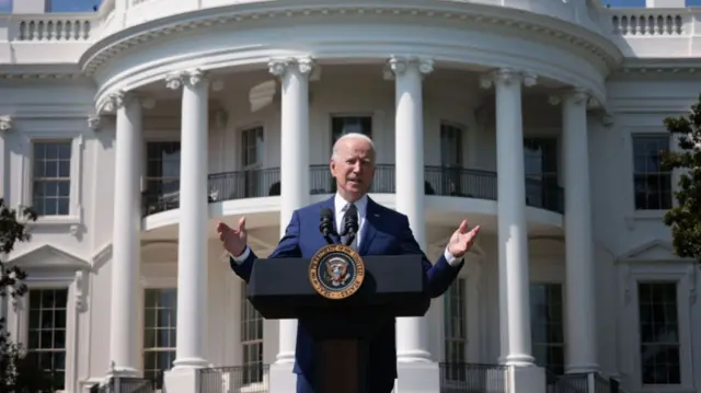 President Biden stands in front of the White House