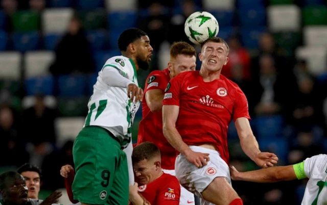 Sam Todd (C-R) of Larne in action against Willem Geubbels (C-L) of St.Gallen