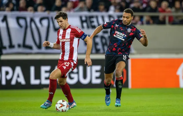 ATHENS, GREECE - NOVEMBER 07: Olympiacos' Panagiotis Retsos and Rangers' Cyriel Dessers in action during a UEFA Europa League 2024/25 League Phase MD4 match between Olympiacos and Rangers at The Georgios Karaiskakis Stadium, on November 07, 2024, in Athens, Greece. (Photo by Alan Harvey / SNS Group)