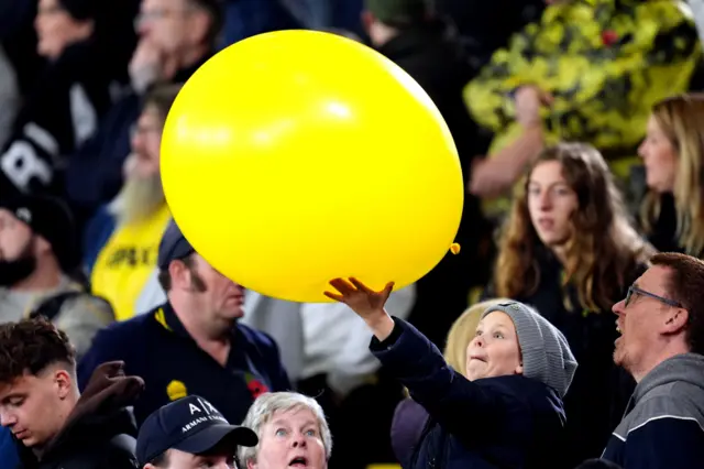 An Oxford United fan with a very large yellow balloon before the Sky Bet Championship match at Vicarage Road, Watford