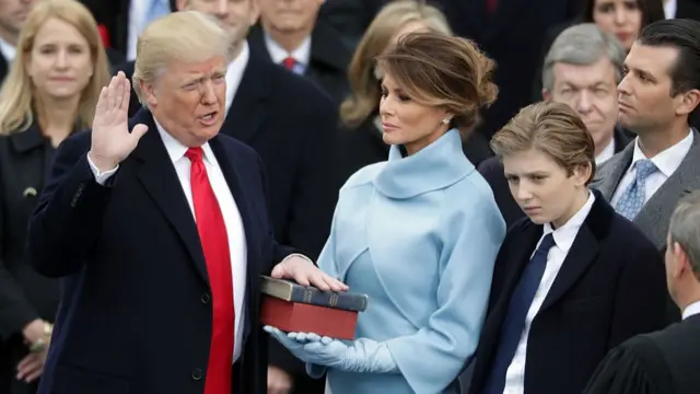 JANUARY 20: (L-R) U.S. President Donald Trump takes the oath of office as his wife Melania Trump holds the bible and his son Barron Trump looks on, on the West Front of the U.S. Capitol on January 20, 2017