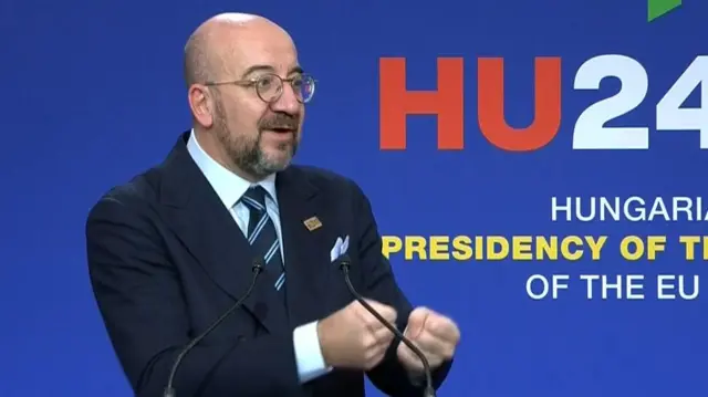 Charles Michel speaking into two microphones