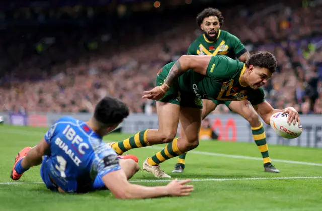 Latrell Mitchell beats Joshua Suaalii of Samoa to score Australia's first try during the rugby league World Cup Final at Old Trafford in November 2022