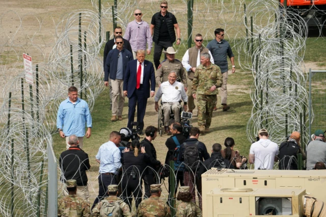 Donald Trump walks next to Texas Governor Greg Abbott on a visit to the US-Mexico border in February 2024