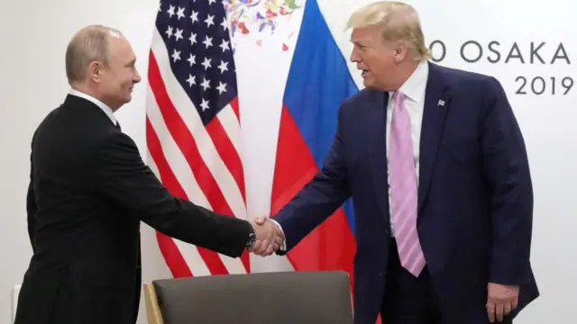 The two men shake hands