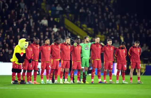 Watford players stand in memory for Remembrance before the Championship match at Vicarage Road, Watford