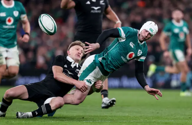 Mack Hansen is tackled by Damian McKenzie