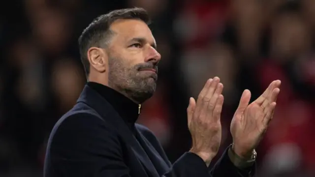 Manchester United interim manager Ruud van Nistelrooy applauds the fans