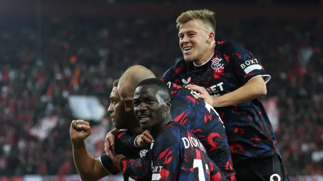 Rangers players celebrate after Cyriel Dessers scores against Olympiakos