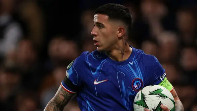 Enzo Fernandez of Chelsea holding a football during a game