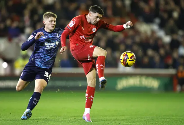 Rotherham United's Ciaran McGuckin (left) and Barnsley's Corey O'Keeffe battle for the ball