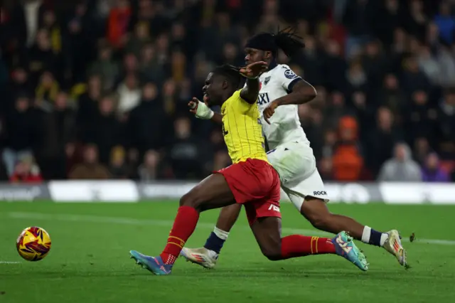 Festy Ebosele of Watford is tackled by Peter Kioso of Oxford United