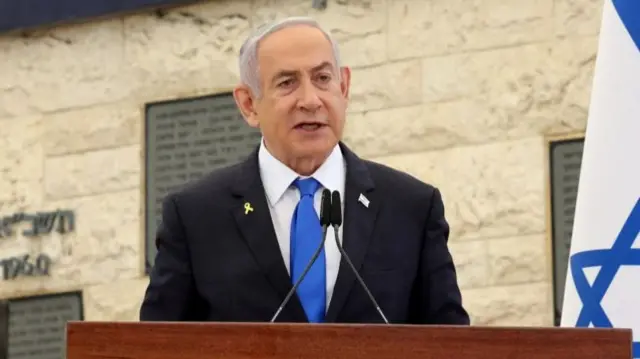 Israeli Prime Minister Benjamin Netanyahu addresses an audience from a lectern