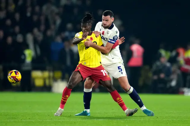 Watford's Vakoun Issouf Bayo (left) and Oxford United's Elliott Moore battle for the ball