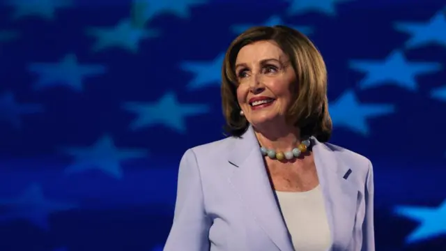 Nancy Pelosi smiling and looking to the left.