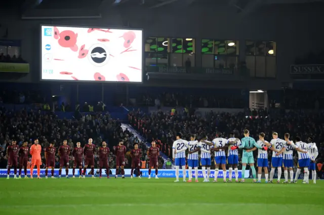 Both sets of players stand in the centre circle for a moment's silence