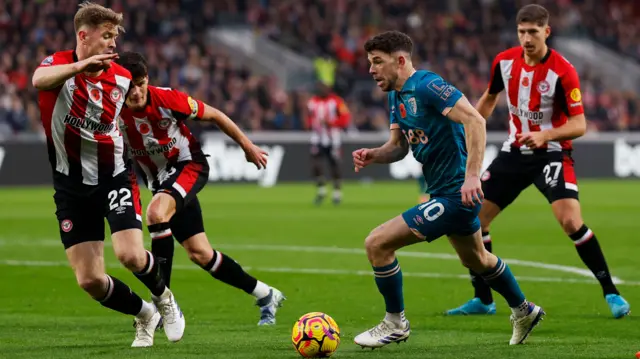 Bournemouth's Ryan Christie takes on Brentford players.