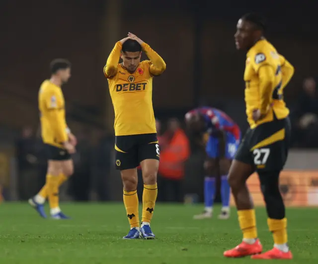 Wolves players with hands on their heads