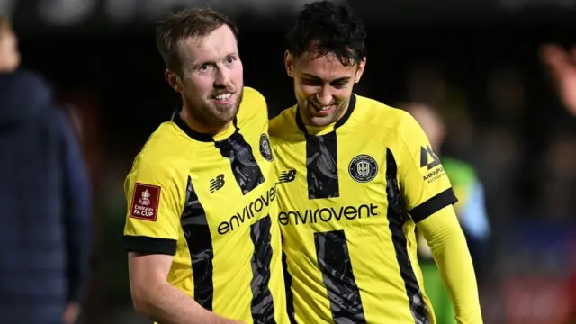 Harrogate's Stephen Dooley and Levi Sutton celebrate FA Cup success against Wrexham