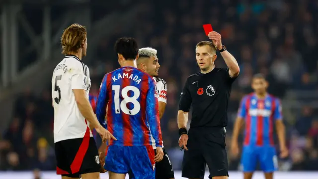 Crystal Palace's Daichi Kamada is shown a red card by referee Michael Salisbury