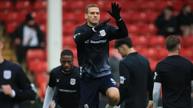 Crewe players warm up at the Bescot