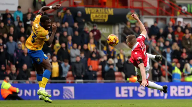 Wrexham striker Paul Mullin tries to connect with an acrobatic volley