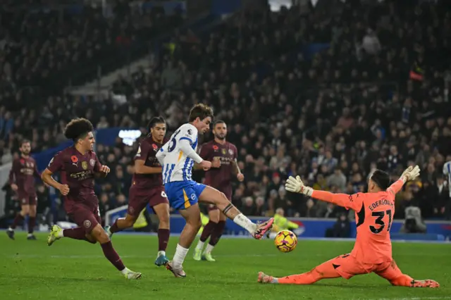 Matt O'Riley slides the ball past Ederson to put Brighton ahead